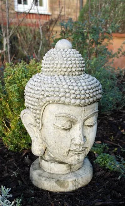 Stone Buddha Head garden statue on a round base
